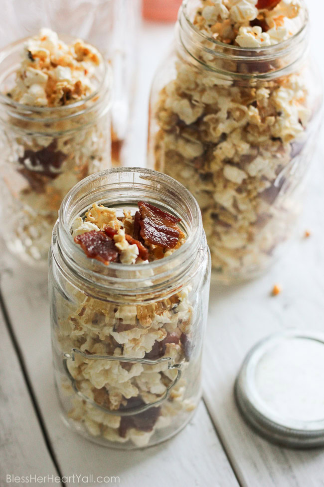 This maple, bacon, bourbon popcorn hits all the right spots, with it's freshly popped popcorn, sprinkled with thick-cut applewood bacon, and then drizzled with butter, salt, maple syrup, and of course bourbon! It's a quick, easy, and inexpensive DIY gift for friends, co-workers, and host/hostess's this holiday season! www.blessherheartyall.com DIY Hostess Gift: Maple, Bacon, Bourbon Popcorn