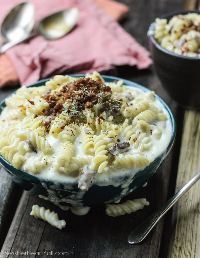 This spicy gluten-free mac and cheese recipe will blow your socks off in under 30 minutes! Let's combine bacon, mushrooms, truffle oil, some heat, and mac and cheese, shall we? Then we will create spicy, creamy, cheesy perfection. www.blessherheartyall.com