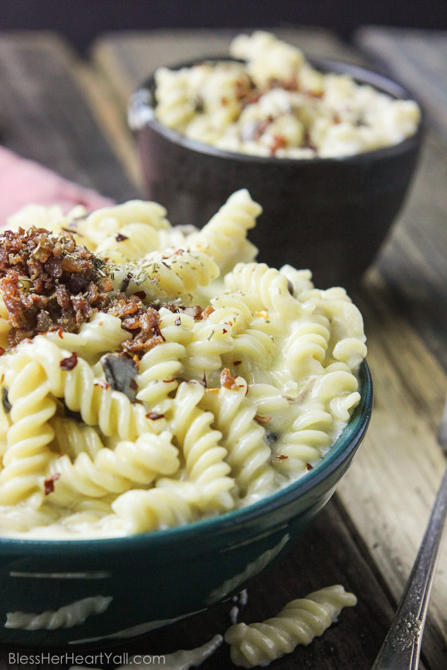 This spicy gluten-free mac and cheese recipe will blow your socks off in under 30 minutes! Let's combine bacon, mushrooms, truffle oil, some heat, and mac and cheese, shall we? Then we will create spicy, creamy, cheesy perfection. www.blessherheartyall.com