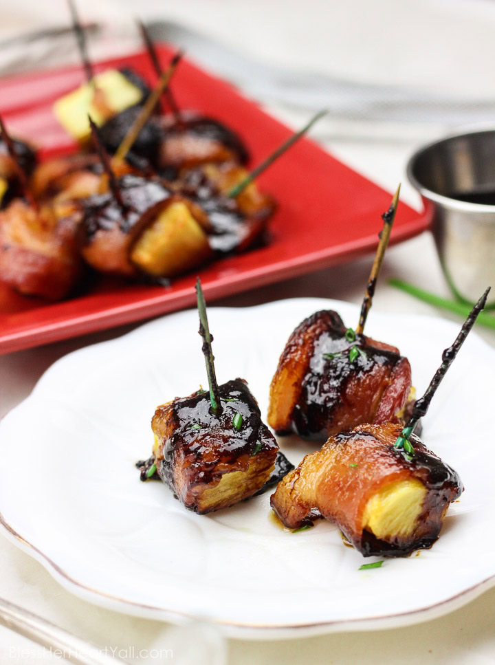 These bacon wrapped pineapple with sriracha lime glaze bites are an easy to-put-together appetizer for any party! Juicy pineapple is wrapped up in thick-cut applewood smoked bacon and then drizzled with a sriracha lime glaze before being baked in the oven to sweet and savory perfection! Yum! www.BlessHerHeartYall.com