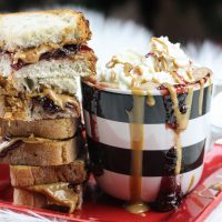 This peanut butter hot chocolate is a decadent and rich twist on the classic hot chocolate. Melting smooth chocolate with creamy peanut butter and sweetened with your favorite berry flavor, (and of course topped with whipped cream and other goodies!) make this an instant cold-weathered favorite.