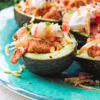 These chicken taco avocado boats are a quick and tasty option for your party or appetizer table. These are a healthy alternative to tacos while keeping that punch of flavor! www.BlessHerHeartYall.com