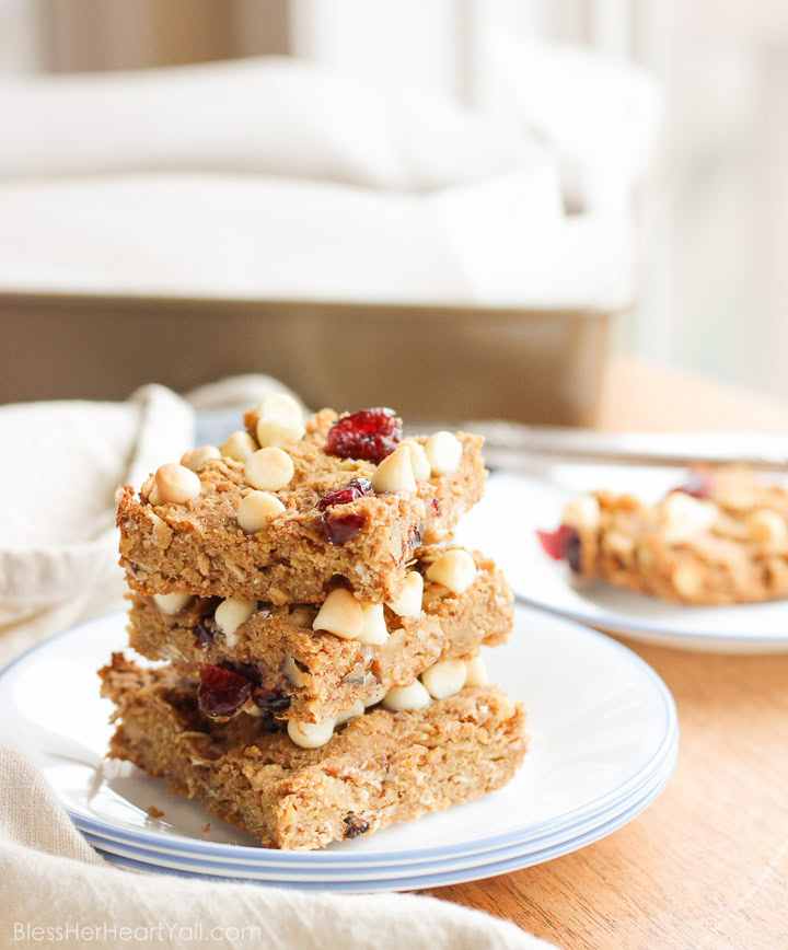 These gluten-free quinoa breakfast bars are a sweet and easy breakfast option for those on-the-go mornings. These breakfast / protein bars combine quinoa, coconut flour, honey, and peanut butter with dried fruits and white chocolate chips to make a delicious baked gluten-free breakfast! www.BlessHerHeartYall.com