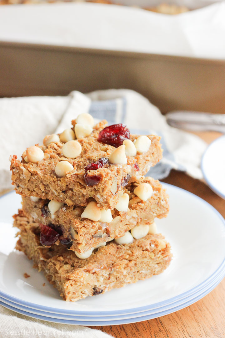 These gluten-free quinoa breakfast bars are a sweet and easy breakfast option for those on-the-go mornings. These breakfast / protein bars combine quinoa, coconut flour, honey, and peanut butter with dried fruits and white chocolate chips to make a delicious baked gluten-free breakfast! www.BlessHerHeartYall.com