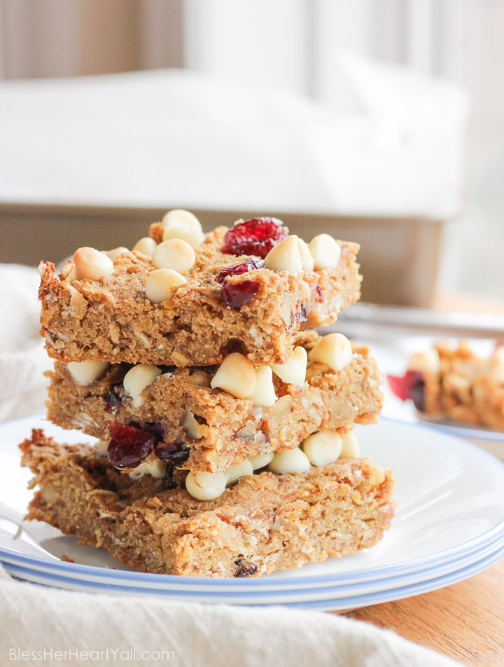 These gluten-free quinoa breakfast bars are a sweet and easy breakfast option for those on-the-go mornings. These breakfast / protein bars combine quinoa, coconut flour, honey, and peanut butter with dried fruits and white chocolate chips to make a delicious baked gluten-free breakfast! www.BlessHerHeartYall.com