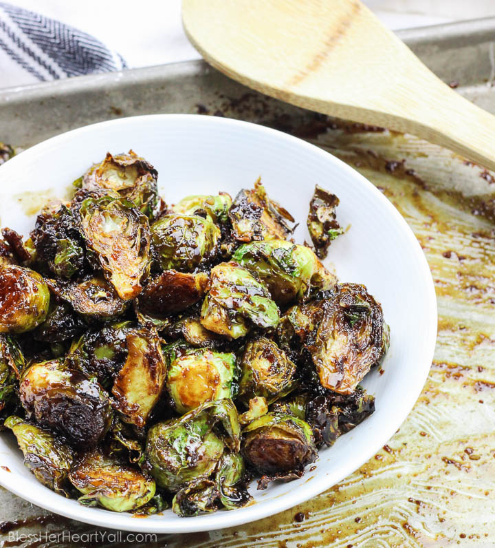 These roasted bacon walnut brussel sprouts are an easy side dish full of sweet hearty flavors! The sprouts are roasted in lemon juice and olive oil before being drizzled with a bacon walnut reduction and then quickly roasted again! www.BlessHerHeartYall.com