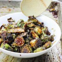 These roasted bacon walnut brussel sprouts are an easy side dish full of sweet hearty flavors! The sprouts are roasted in lemon juice and olive oil before being drizzled with a bacon walnut reduction and then quickly roasted again! www.BlessHerHeartYall.com