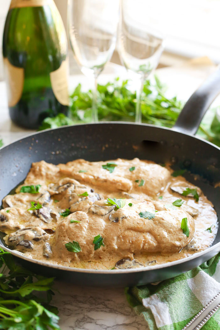 champagne chicken with mushrooms cooked in skillet on dinner table