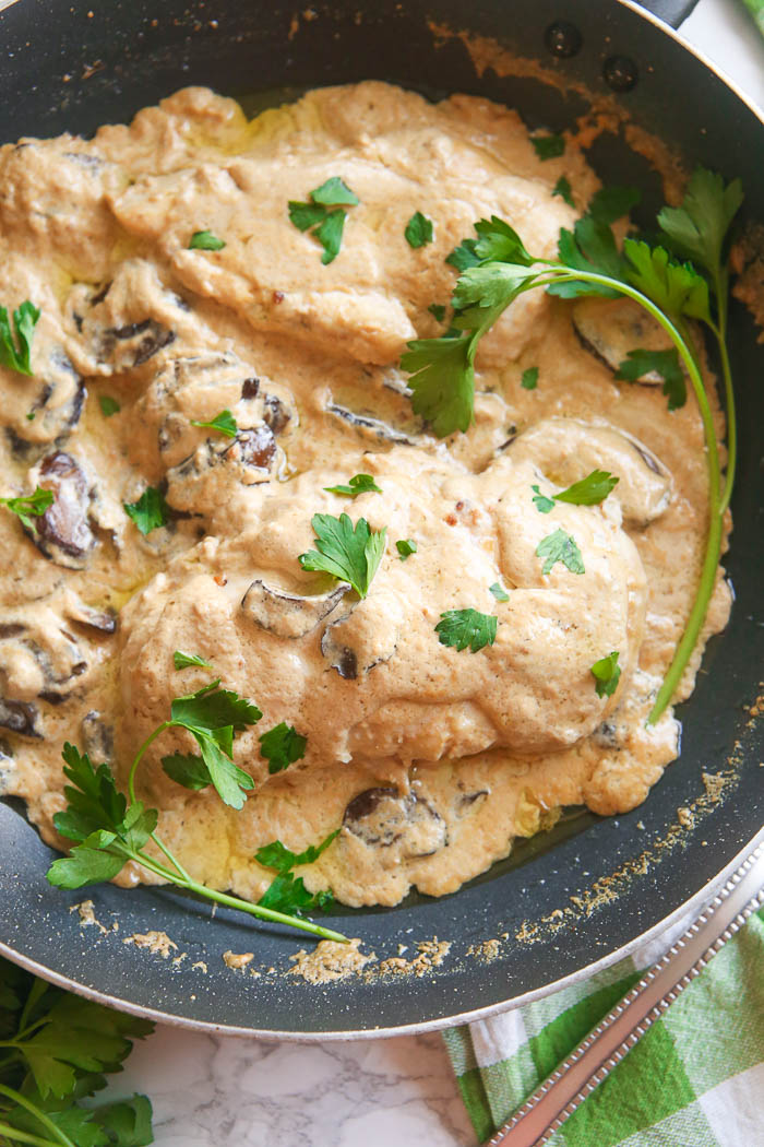 champagne chicken with mushrooms cooked in skillet close up shot