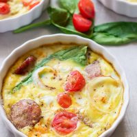 This gluten-free protein packed goat cheese egg bake combines the protein punch of fresh eggs, spinach, and breakfast sausage, with the flavors of creamy goat cheese, tomatoes and a little sweet onion slices for one amazing baked breakfast to fuel your morning right!