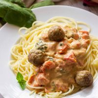 This easy goat cheese spaghetti and meatballs recipe combines fresh goat cheese, smashed tomatoes, and fresh basil, garlic, and onion for a delicious meal in less than 20 minutes!