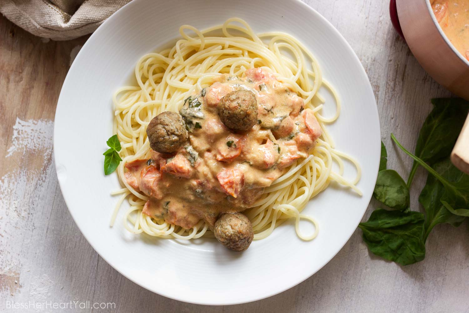 This easy goat cheese spaghetti and meatballs recipe combines fresh goat cheese, smashed tomatoes, and fresh basil, garlic, and onion for a delicious meal in less than 20 minutes!