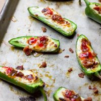 These bacon goat cheese jalapeno poppers are a fast and delicious little appetizer full of creamy goat cheese, crisp bacon crumbles, and sweet pepper jelly overtop quickly charred jalapenos for the perfect sweet and spicy party treat!