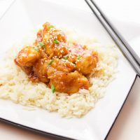 This one-pan baked gluten-free sweet and sour chicken recipe is 100% gluten-free and not fried in a frying pan for even a second. Tender pieces of chicken are lightly breaded in a homemade spiced coating and then drizzled in coconut oil and a sweet and tangy sticky sauce and then baked to perfection.