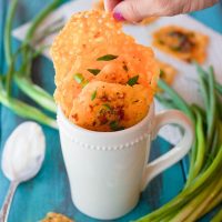 Loaded bacon cheddar crisps are the perfect 5 ingredient baked finger food for your next party! They combine cheddar, bacon, garlic, and green onion into a gluten-free and low carb snack that takes just minutes to make! Place a dollop of sour cream on them and you have a new easy low carb version of loaded potato skins!