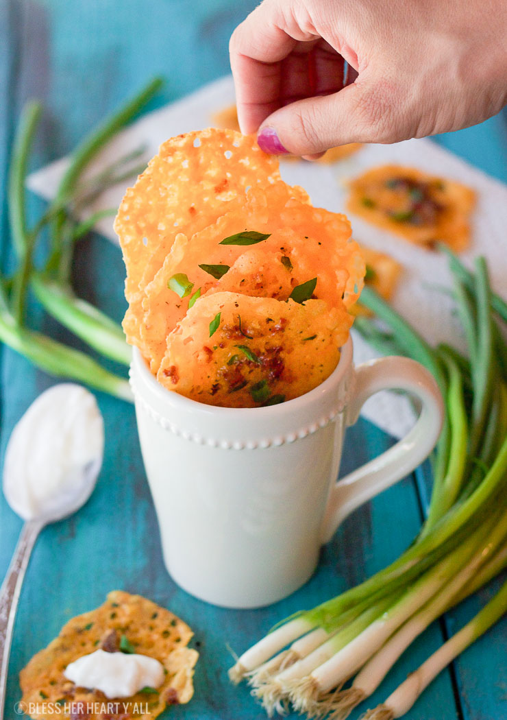 Loaded bacon cheddar crisps are the perfect 5 ingredient baked finger food for your next party! They combine cheddar, bacon, garlic, and green onion into a gluten-free and low carb snack that takes just minutes to make! Place a dollop of sour cream on them and you have a new easy low carb version of loaded potato skins!