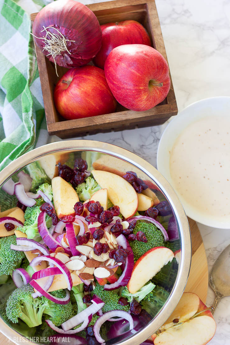 This healthy fall broccoli salad is gluten-free, grain-free, vegetarian, and is with bursting with autumn flavor! Greek yogurt, honey, lime juice, fresh and dried fruits, and almonds are tossed together to create a light, sweet, and creamy drizzle that's perfect for any fall table setting!