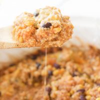 This slow cooker mexican quinoa dip is the perfect gluten-free, vegetarian, and paleo friendly tailgating comfort food! It's warm and gooey, filling and nutritious, and cooks itself in the slow cooker for a quick 2-3 hours. Use this recipe as a dip with your favorite sweet potato chips, rolled up in a tortilla for a quick enchilada, or toss it over a salad to add a burst of flavor!