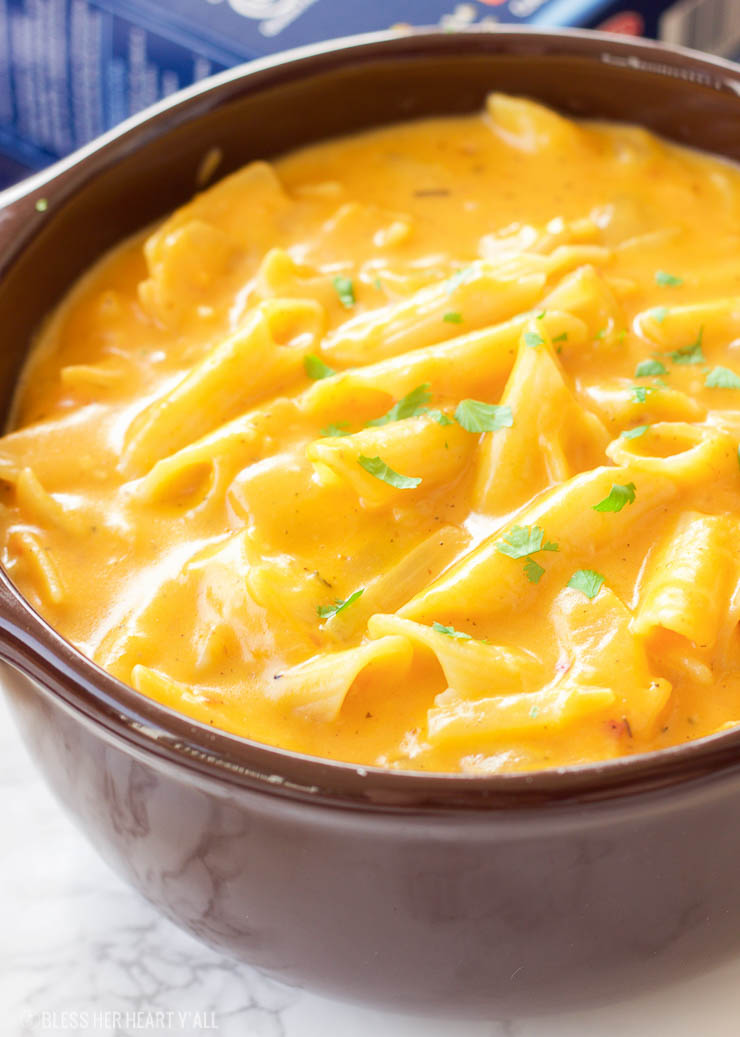 This gluten-free pumpkin macaroni and cheese recipe is the ultimate cheesy fall comfort food. Gluten-free noodles are cooked in a pumpkin, sage, and nutmeg sauce and just before serving are smothered in gooey cheddar and parmesan cheeses.