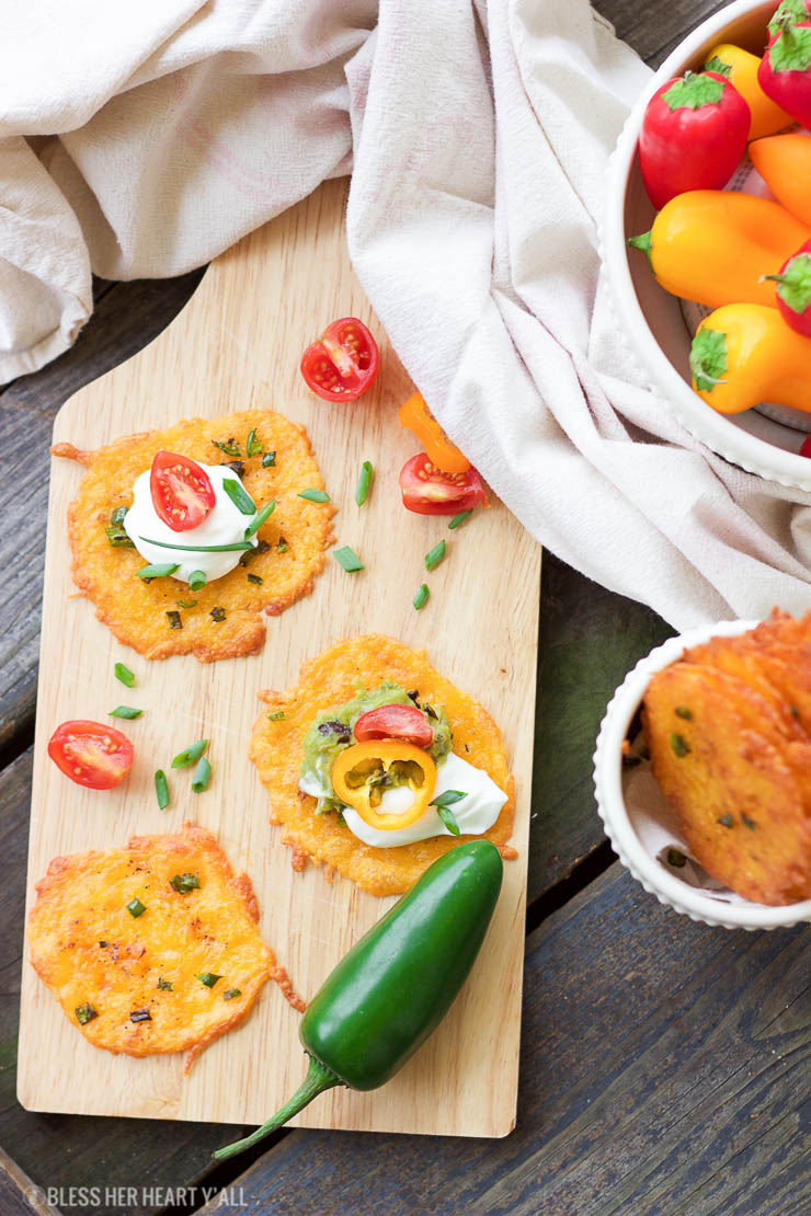 Taco cheese crisps are an easy and quick baked party recipe! These crispy cheese dippers are the perfect appetizer or snack for any gluten-free or low carb munchers and are huge hits at tailgating parties! All you need is cheddar cheese, taco seasoning, your favorite taco toppings, and a few minutes of oven time! Yes!