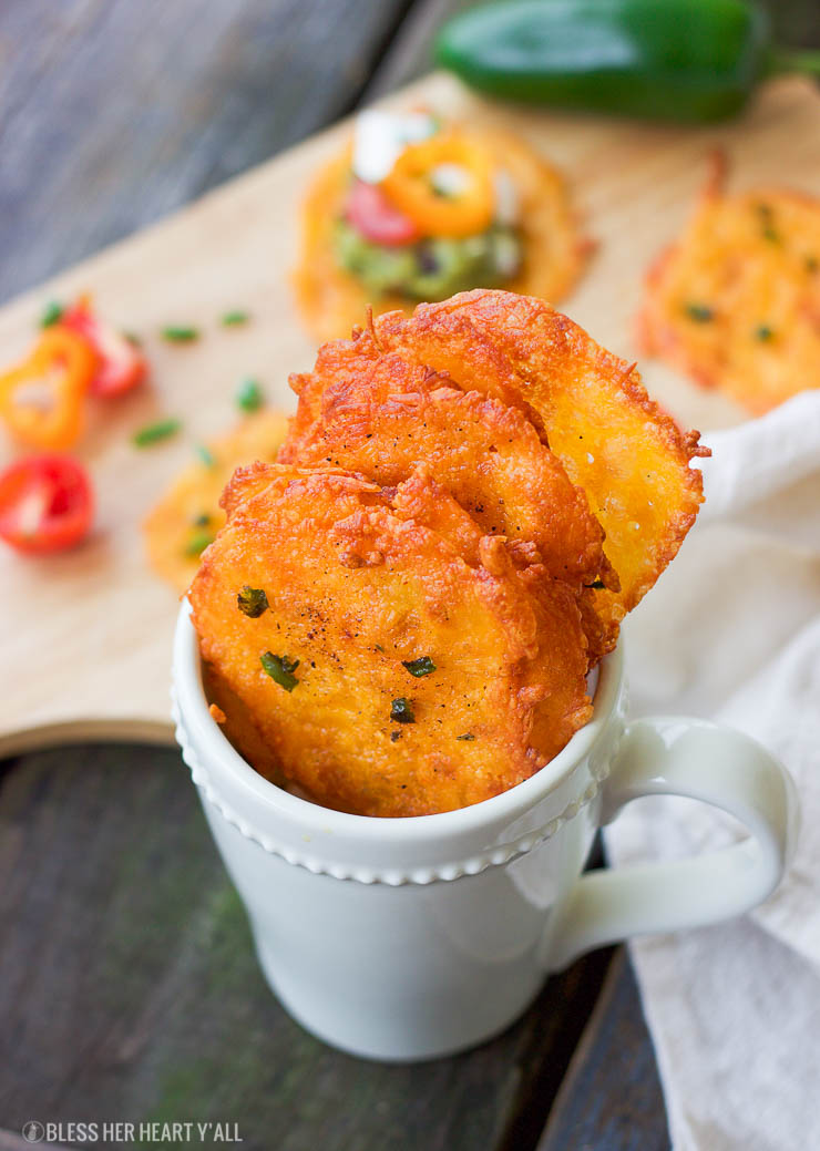 Taco cheese crisps are an easy and quick baked party recipe! These crispy cheese dippers are the perfect appetizer or snack for any gluten-free or low carb munchers and are huge hits at tailgating parties! All you need is cheddar cheese, taco seasoning, your favorite taco toppings, and a few minutes of oven time! Yes!