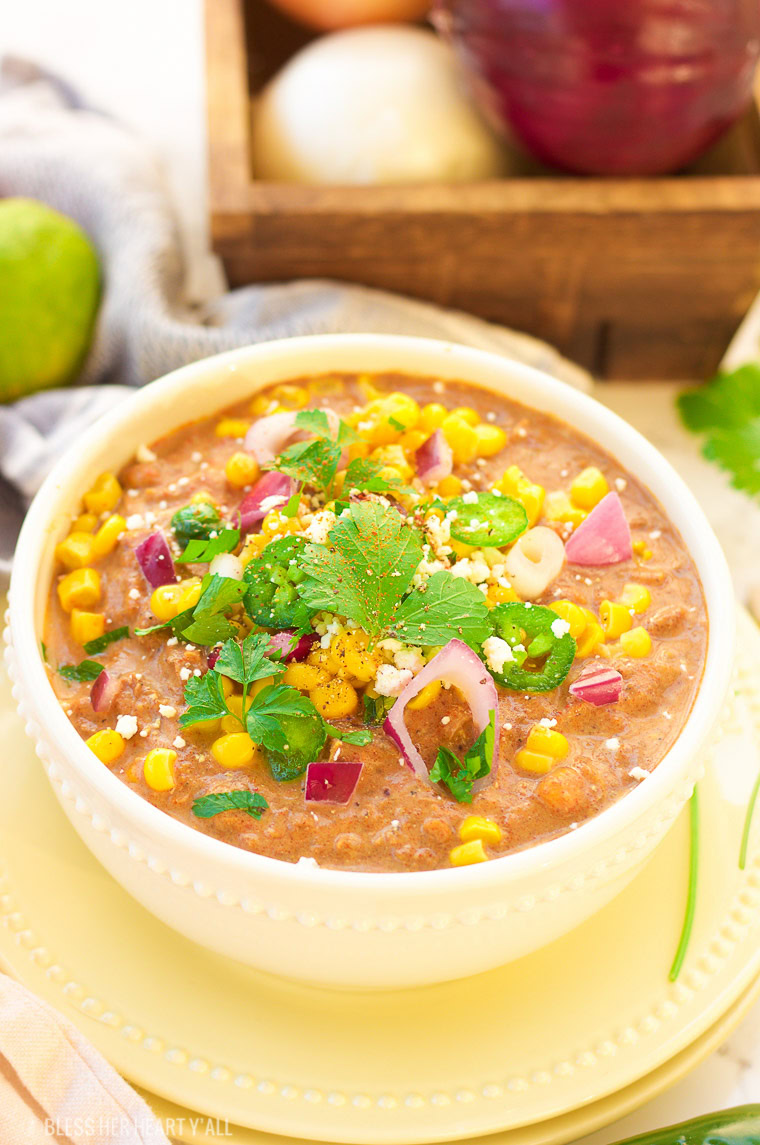 This slow cooker white turkey chili combines juicy leftover roasted turkey, chunky vegetables, and garlic, oregano, paprika, and spice to make a delicious stick-to-your-ribs meal that's so simple to make and so comforting to eat! It's also gluten free, dairy free and low carb! www.blessherheartyall.com