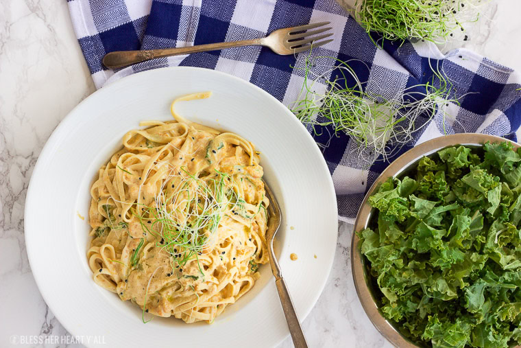 This vegan butternut squash pasta with kale and onion sprouts recipe is not only a showstopper, but it's packed full of nutrients and is also gluten-free, grain free, dairy free, and paleo friendly. Dive into this creamy savory dish in under 15 minutes! www.BlessHerHeartYall.com