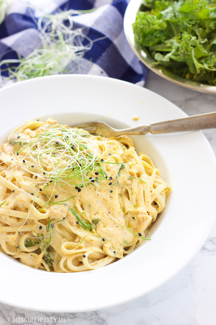 This vegan butternut squash pasta with kale and onion sprouts recipe is not only a showstopper, but it's packed full of nutrients and is also gluten-free, grain free, dairy free, and paleo friendly. Dive into this creamy savory dish in under 15 minutes! www.BlessHerHeartYall.com