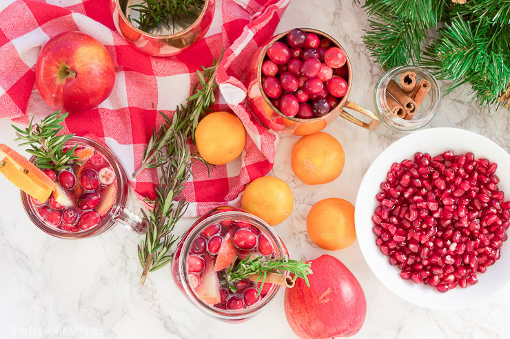 This winter pomegranate cranberry sangria recipe is a quick and easy twist on the popular sangria drink. Impress everyone at your next holiday or Christmas party with this sparkling red wine cocktail with apples, oranges, pomegranate, cranberry, rosemary, and cinnamon sticks! Get your drink on fancy pants!