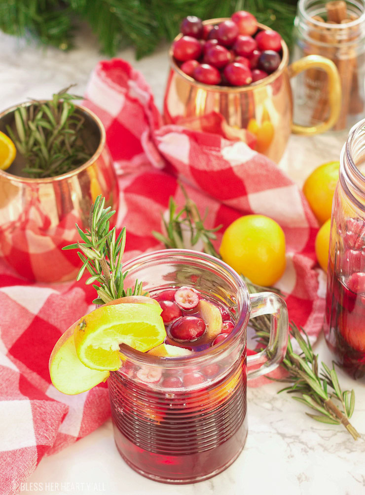 This winter pomegranate cranberry sangria recipe is a quick and easy twist on the popular sangria drink. Impress everyone at your next holiday or Christmas party with this sparkling red wine cocktail with apples, oranges, pomegranate, cranberry, rosemary, and cinnamon sticks! Get your drink on fancy pants!