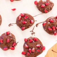 Dark chocolate pomegranate bites are the perfect quick and easy appetizer or sweet snack for the holiday season! Melted dark chocolate is sprinkled with pomegranate arils and sea salt before being allowed to harden and disappear.