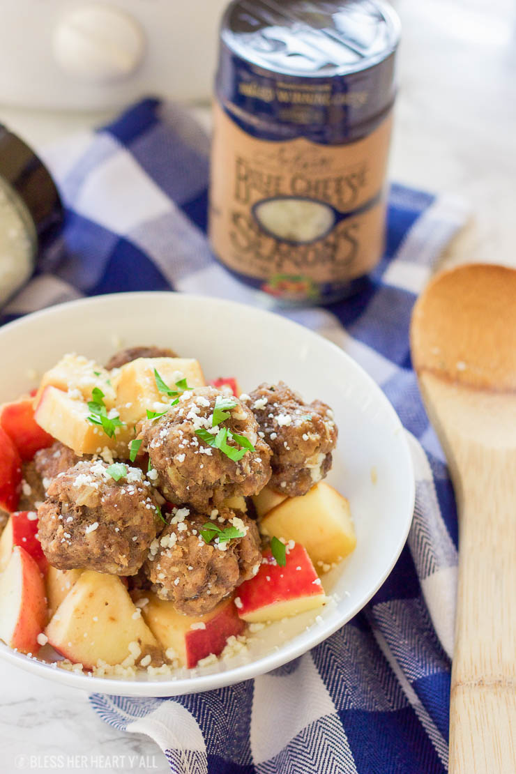 This easy slow cooker apple cider meatball recipe dunks fresh meatballs and juicy apple slices in apple cider, garlic, and blue cheese crumbles for a delicious fall spin. Bring them to a fall party and they will be gone in seconds! www.BlessHerHeartYall.com