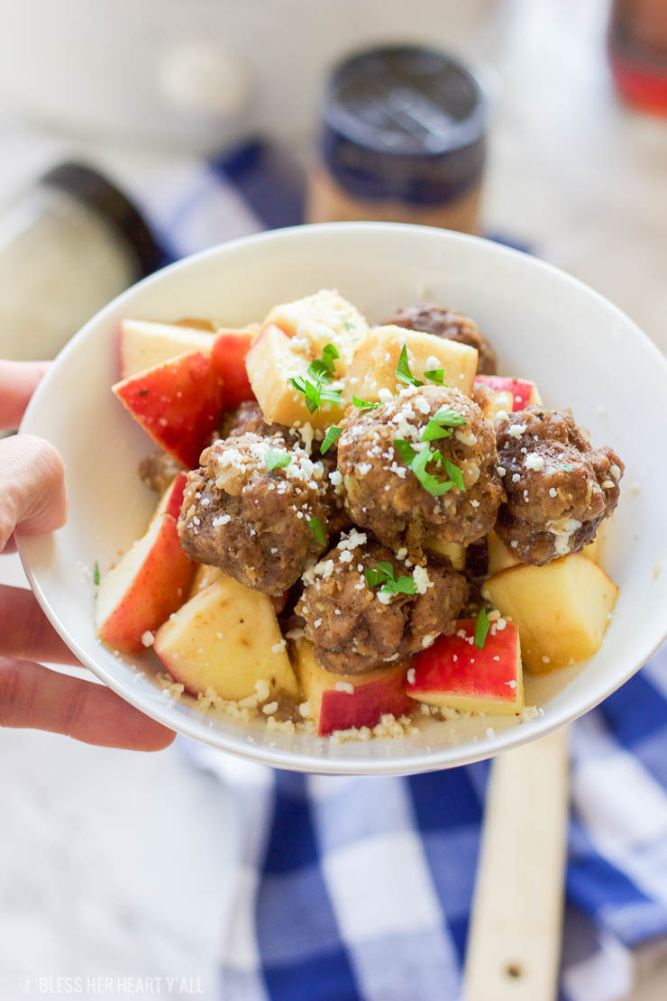 This easy slow cooker apple cider meatball recipe dunks fresh meatballs and juicy apple slices in apple cider, garlic, and blue cheese crumbles for a delicious fall spin. Bring them to a fall party and they will be gone in seconds! www.BlessHerHeartYall.com