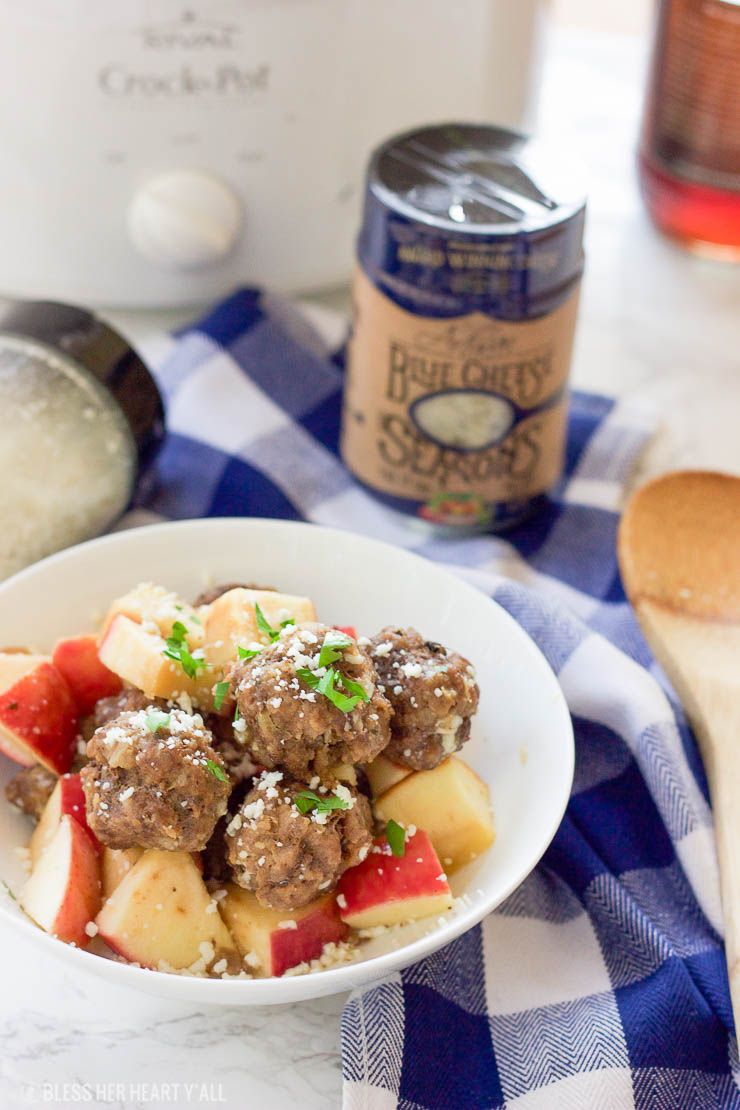 This easy slow cooker apple cider meatball recipe dunks fresh meatballs and juicy apple slices in apple cider, garlic, and blue cheese crumbles for a delicious fall spin. Bring them to a fall party and they will be gone in seconds! www.BlessHerHeartYall.com