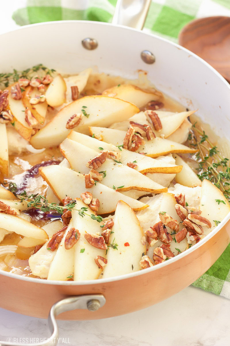 This pear pecan chicken skillet roasts juicy chicken breasts in a sweet and savory honey and thyme sauce, topped to perfection with roasted pears and chopped pecans. This is one easy weeknight recipe you can't pass up!