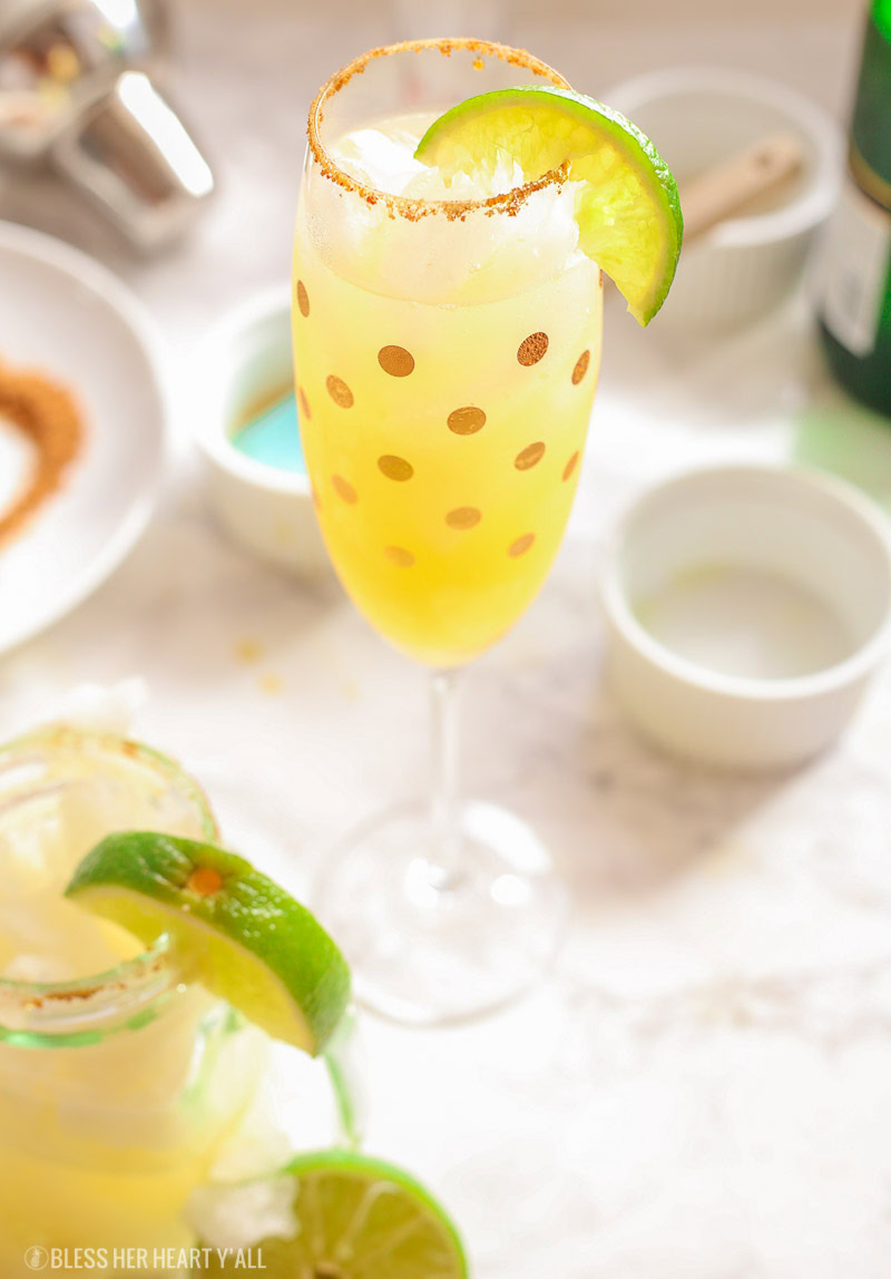 These skinny champagne margaritas are epicly delicious and prepared two different ways. There is no need for sugar or simple syrup for this recipe that uses a combination of fresh lime and orange juices as well as honey to sweeten and packs a punch with it's tequila and champagne, perfect for any New Year's Eve fiesta!