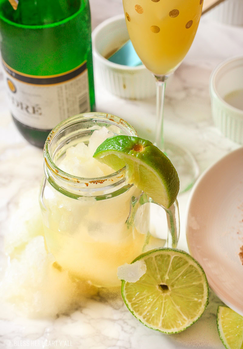 These skinny champagne margaritas are epicly delicious and prepared two different ways. There is no need for sugar or simple syrup for this recipe that uses a combination of fresh lime and orange juices as well as honey to sweeten and packs a punch with it's tequila and champagne, perfect for any New Year's Eve fiesta!