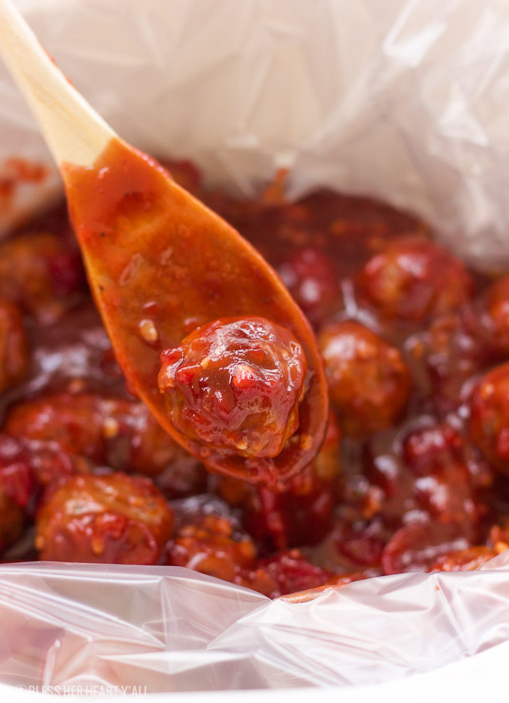 These spicy cranberry bacon bbq meatballs are the ultimate in sticky finger foods just in time for the holidays! A quick homemade cranberry sauce is melted and smothered into barbecue sauce and hot spices for the perfect sweet and spicy no-fuss pop-able party bites!