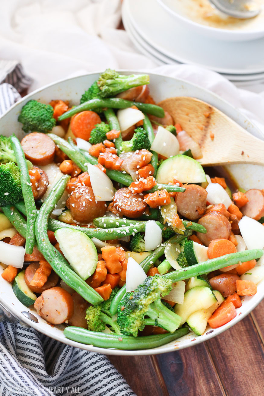 Sweet potato stir fry with chicken sausage slices are combined with fresh vegetables and a simple sweet and savory paleo stir fry sauce for one epically healthy meal your family will ask for time and time again.