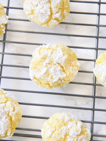 Gluten free lemon crinkle cookies combine light fresh lemon flavors into soft and doughy cookies that are sprinkled in delicious powdered sugar before being baked for a quick 10 minutes!