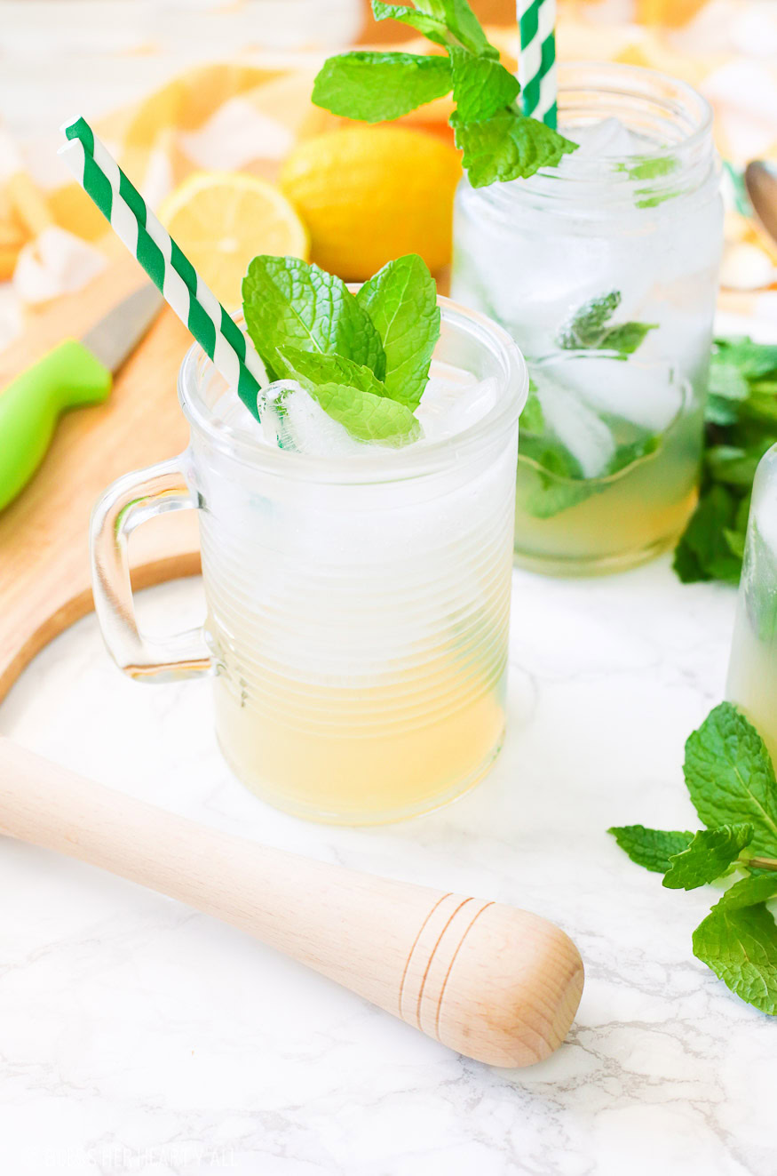 This lemonade mint julep recipe blends summer's most refreshing fresh squeezed lemonade and stirs it up into spring's hottest mint julep cocktail! Lemon, bourbon, mint, and sweet that's perfect for an outdoor party, watching the Kentucky Derby, or just a relaxing time outside on your back porch!