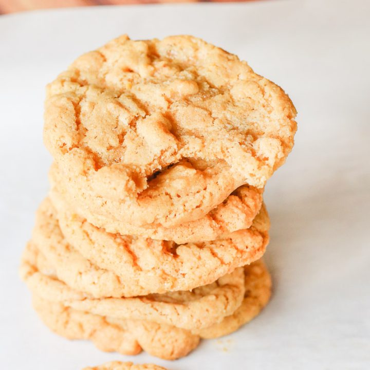 These 4-ingredient gluten free peanut butter cookies take creamy peanut butter, sugar, baking soda, and an egg and in 10 minutes turn it into soft and doughy-centered gluten free peanut butter cookies with perfectly crispy golden brown outer edges. Perfect for dunking in a cold glass of milk!