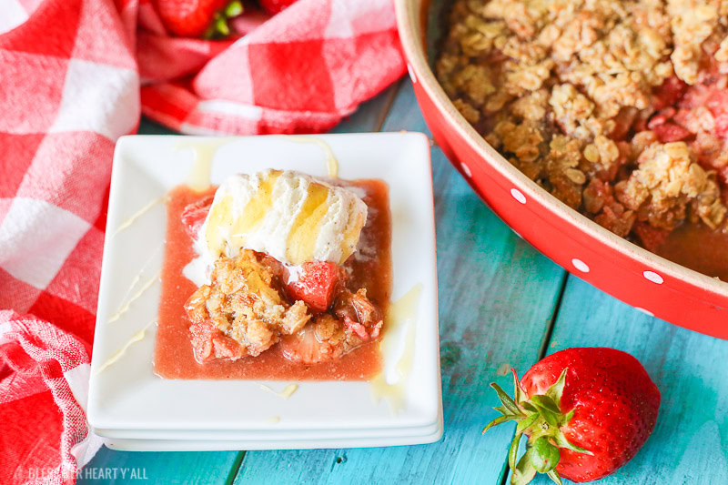 This gluten-free strawberry crumble warms sweet juicy strawberry pieces with a soft and sweet crisp topping. Perfect with vanilla bean ice cream and a drizzle of fresh honey!