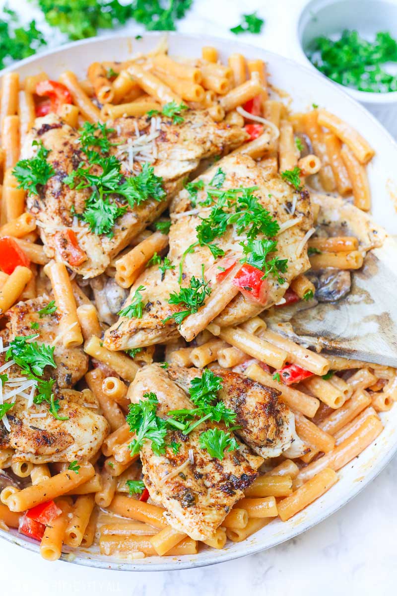 Cajun chicken pasta melts juicy cajun-seasoned chicken breasts with al dente gluten-free noodles in an easy creamy pasta sauce and sprinkled with extra gooey cheeses and herbs all in under 30 minutes! image 6