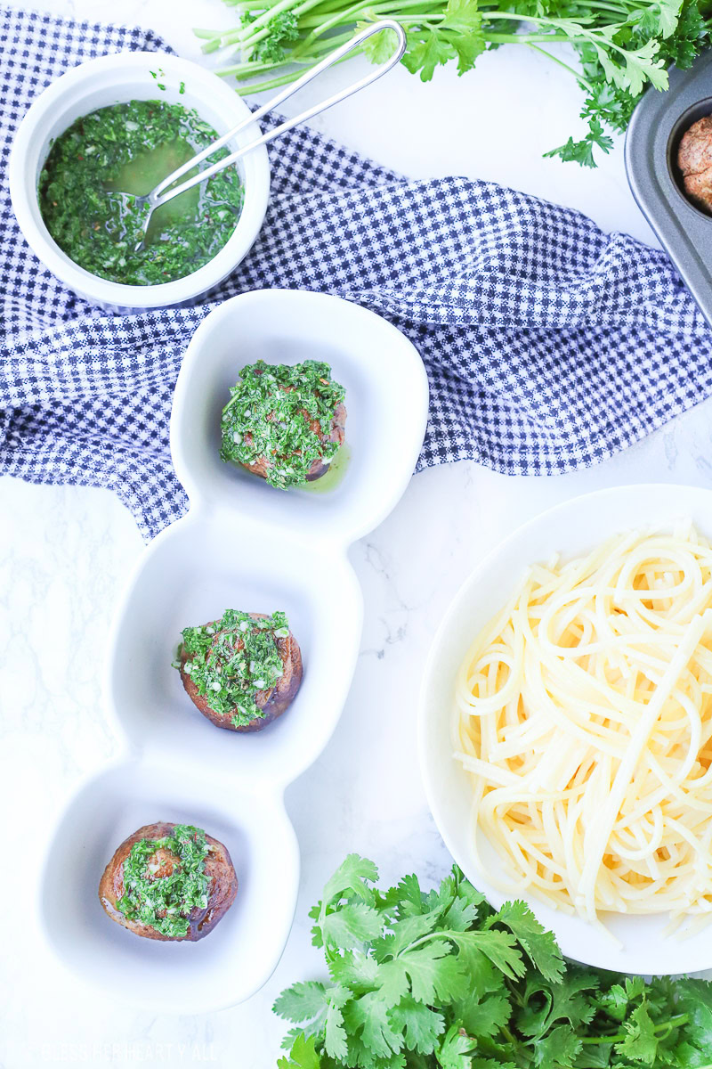 Chimichurri meatballs bake juicy bites of fresh beef and cilantro and then drizzle them with an easy homemade chimichurri sauce! This quick appetizer recipe is low carb, paleo, gluten free!