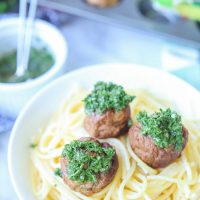 Chimichurri meatballs bake juicy bites of fresh beef and cilantro and then drizzle them with an easy homemade chimichurri sauce! This quick appetizer recipe is low carb, paleo, gluten free!