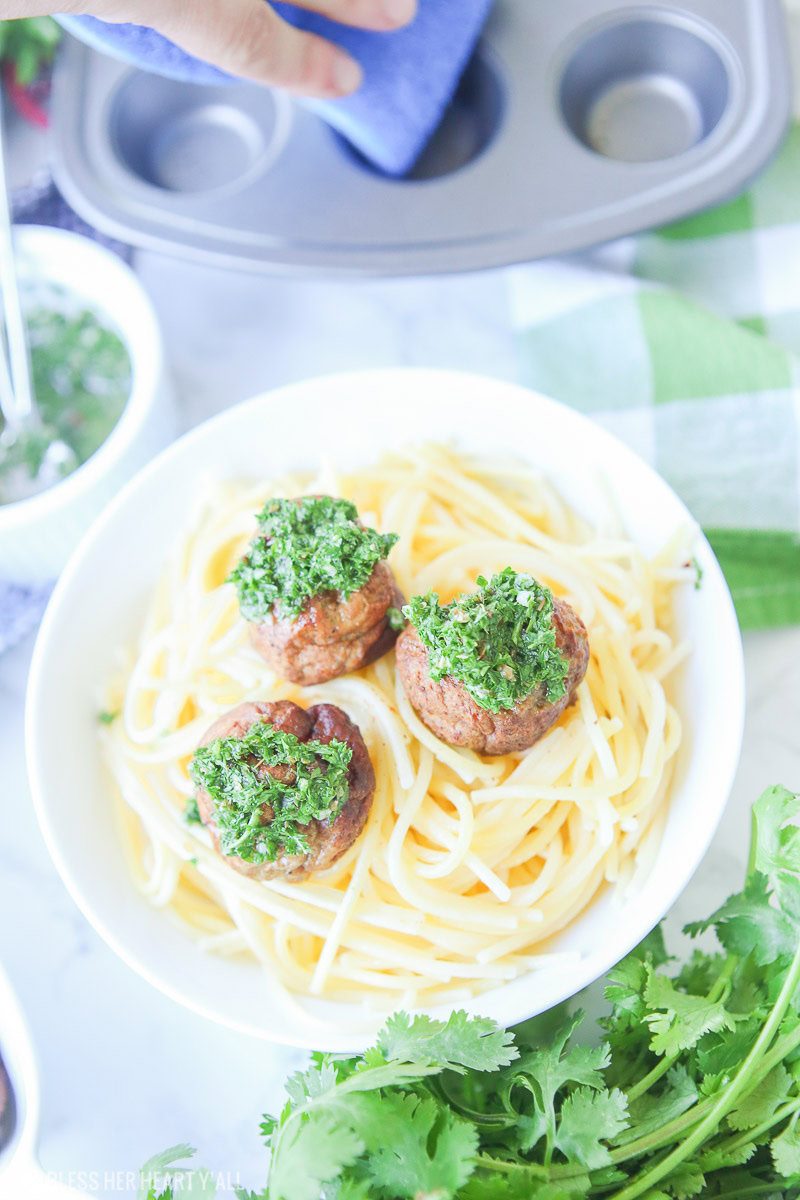 Chimichurri meatballs bake juicy bites of fresh beef and cilantro and then drizzle them with an easy homemade chimichurri sauce! This quick appetizer recipe is low carb, paleo, gluten free!