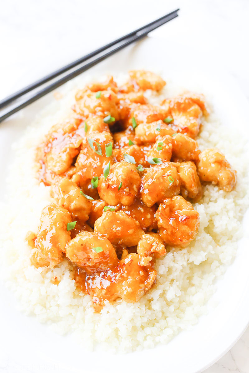 One-pan baked gluten-free sticky honey garlic chicken recipe is 100% gluten free and not fried in a frying pan for even a moment. Tender pieces of chicken are lightly breaded in a homemade spiced coating and then drizzled in coconut oil and a 5-ingredient sticky honey garlic sauce and then baked to perfection. image 1