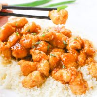 One-pan baked gluten-free sticky honey garlic chicken recipe is 100% gluten free and not fried in a frying pan for even a moment. Tender pieces of chicken are lightly breaded in a homemade spiced coating and then drizzled in coconut oil and a 5-ingredient sticky honey garlic sauce and then baked to perfection. image 6