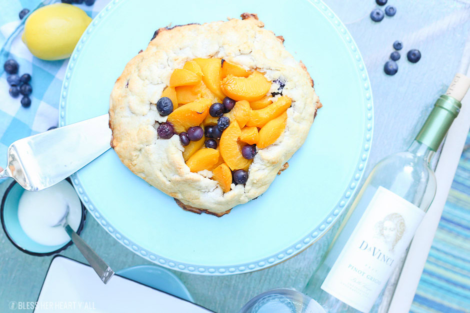 This peach blueberry galette combines peach slices and fresh blueberries in a sweet juicy sauce and then spreads it inside a doughy sugar-lined crust and bakes it all to golden perfection. This gluten free tart is drizzled in a light lemon glaze and is the perfect summer snack to enjoy outside on the back deck with a chilled bottle of white wine!